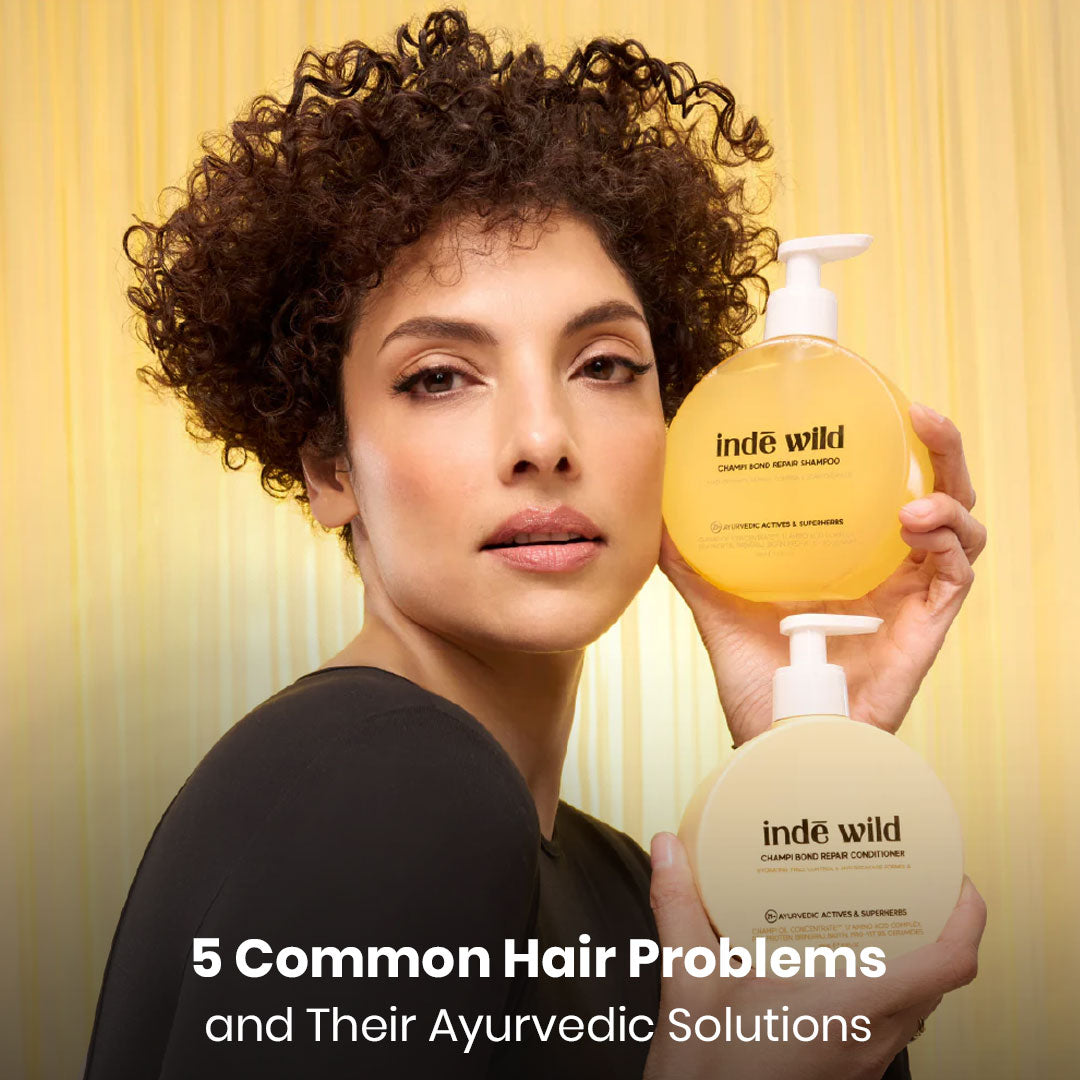 Model holding inde wild hair care products