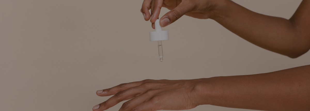 hand holding serum pipette drop 